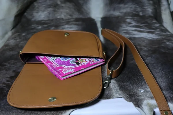 Cowhide buckle crossbody bag with flap closure in genuine leather