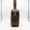 Large cowhide crossbody bag in black brown and orange with box style shape, leather finish, long strap, main compartment and inside pocket