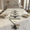 Handmade black and white cowhide table runner with bull head and long horn design, protective synthetic leather backing, ideal for small to large dining tables