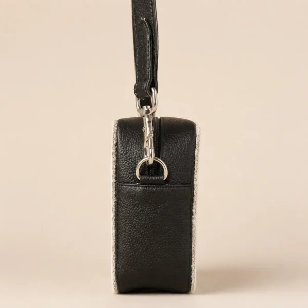 Black cowhide crossbody bag with box style shape, cow finish leather, long strap, large compartment and inside pocket