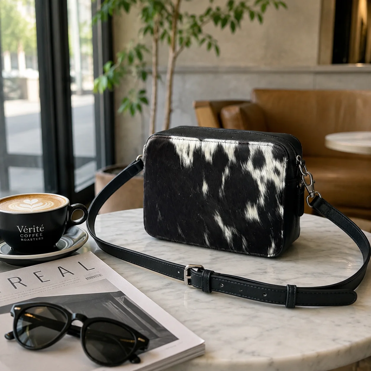 Black cowhide crossbody bag with box style shape, cow finish leather, long strap, large compartment and inside pocket