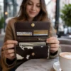 Dark brown black and white cowhide women flip hand wallet with magnetic cover, card holders and zipper compartments