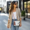 Cowhide mobile phone pouch square style with brown and white cowhide pattern, tan leather strap, zipper pocket and adjustable shoulder strap