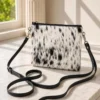 Black and white cowhide mobile phone pouch square style with zipper pocket, cow finished leather strap and adjustable shoulder bag design