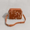 Tan leather cowhide crossbody bag box style purse for women with adjustable strap, large main compartment and inside pocket, structured design