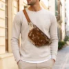 Pink cowhide fanny pack with long fringe and adjustable waist strap
