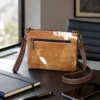 Cowhide mobile phone pouch with hand tooled leather flip and shoulder strap