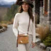 Cowhide mobile phone pouch with hand tooled leather flip and shoulder strap