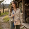 Hand tooled cowhide phone pouch with adjustable shoulder strap