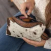 Cowhide toiletry bag with hand tooled leather and zipper compartment