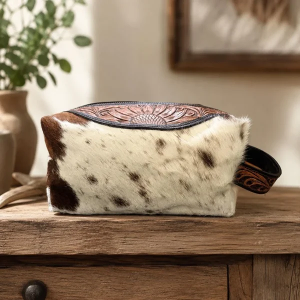 Cowhide toiletry bag with hand tooled leather and zipper compartment