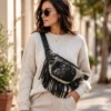 cowhide fanny pack with long fringe and adjustable waist strap