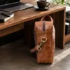Brown leather laptop bag messenger style with shoulder strap