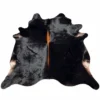 Brazilian cowhide rug in black with brown spine made from genuine cowhide shown on a white background