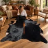 Brazilian cowhide rug in black with brown spine made from genuine cowhide shown in an Australian living room