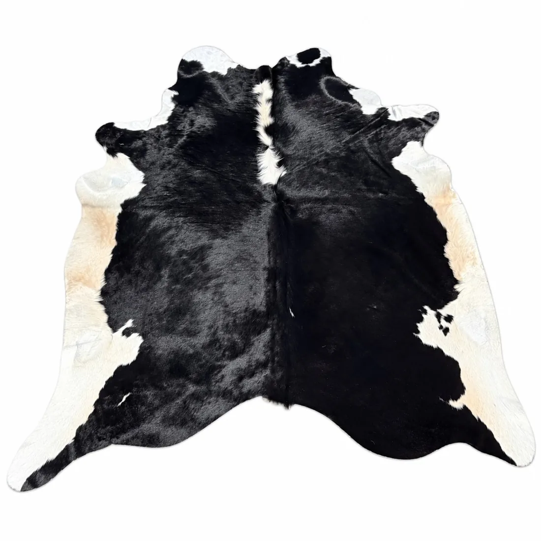 Brazilian cowhide rug in Black with White Edges made from genuine cowhide shown on a white background