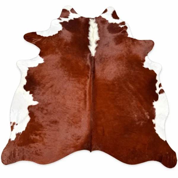 Brazilian cowhide rug in reddish brown and white made from genuine cowhide shown on a white background