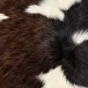 Calf hide rug dark brown white - closeup texture