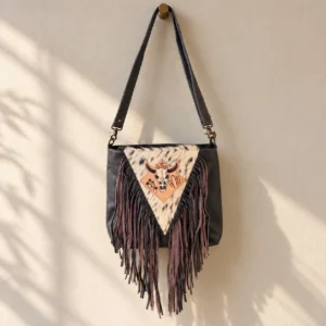 Black cowhide crossbody purse with hand tooled bull head patch