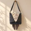 Black cowhide crossbody purse with hand tooled bull head patch