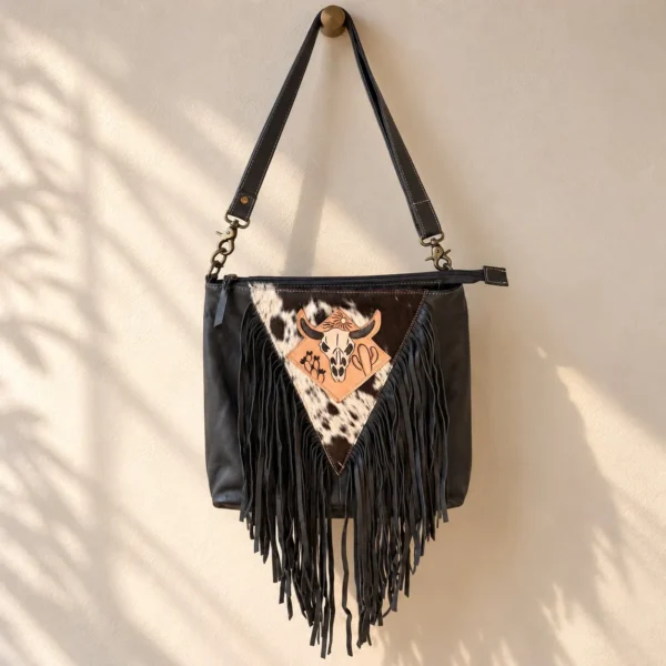 Black cowhide crossbody purse with hand tooled bull head patch