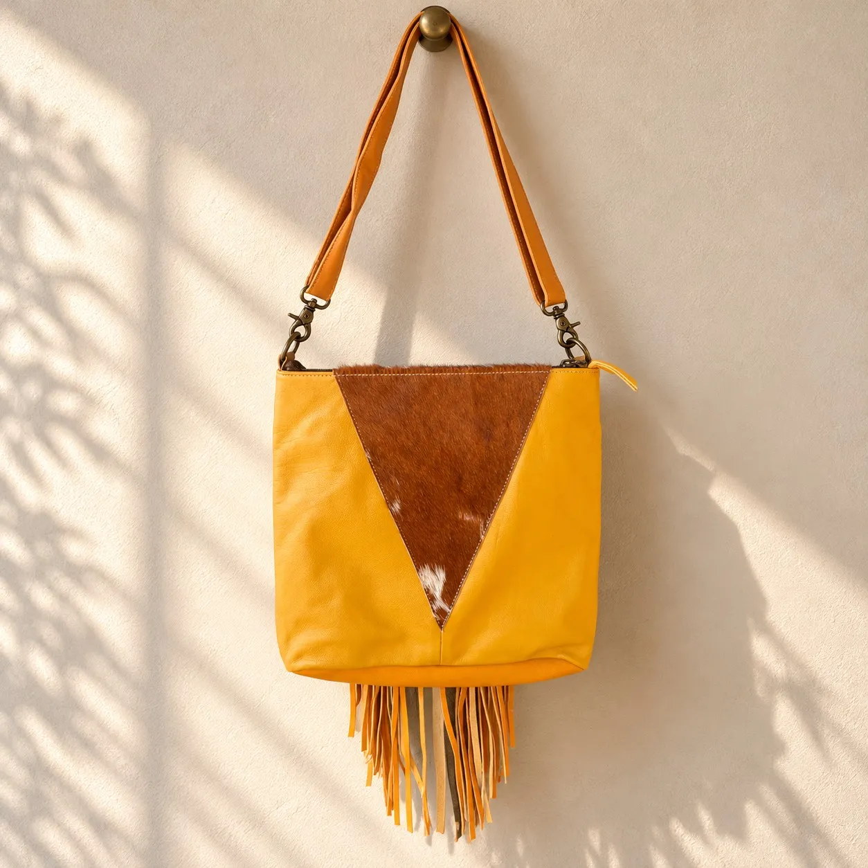 Back view of cowhide crossbody purse with triangle cowhide panel