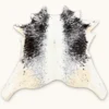 Calf hide rug black white spotted tan edges - main studio